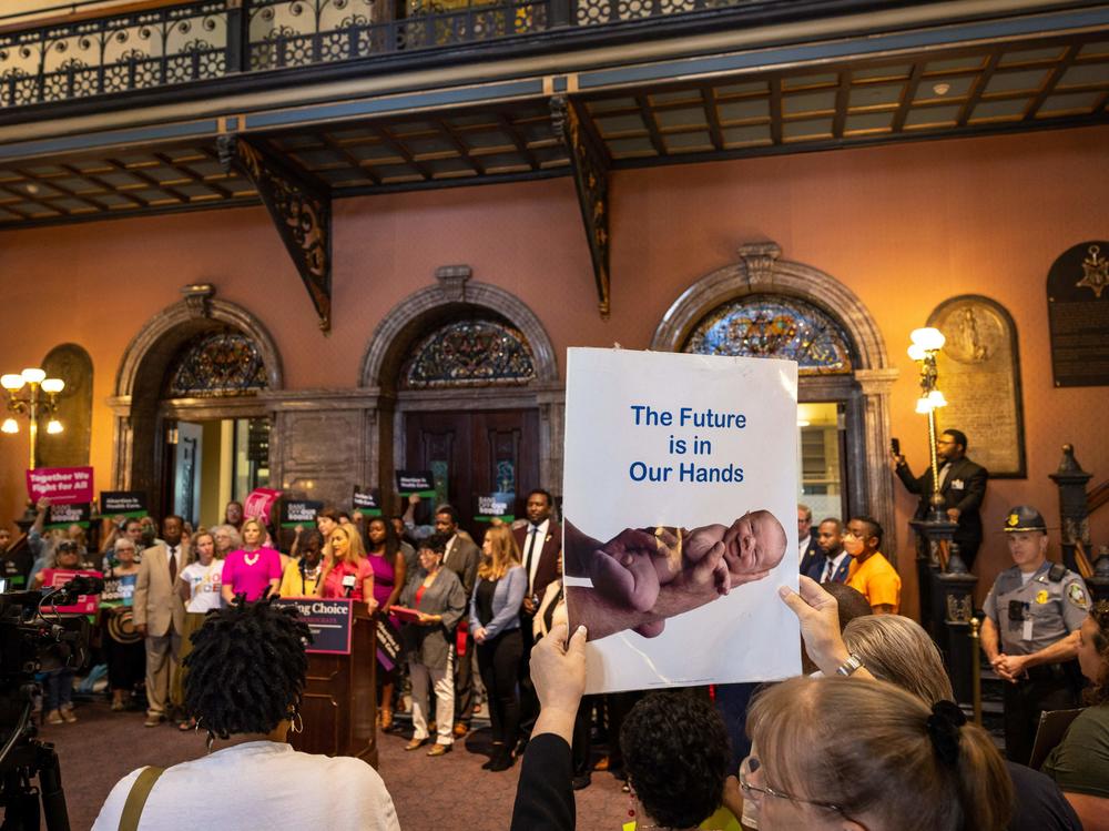 An opponent of abortion rights holds a sign at a press conference outside the South Carolina State House in May 2023. The state's abortion ban went into effect last month.