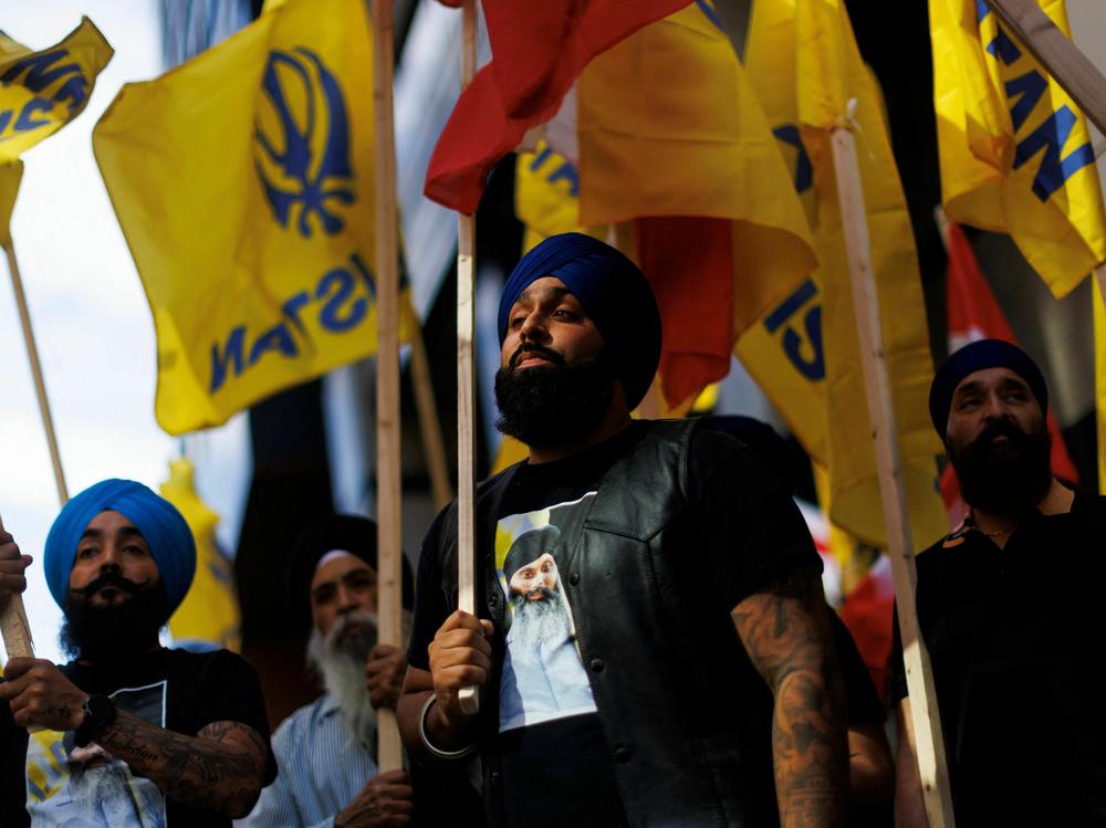 People hold flags during a Sikh rally outside the Indian Consulate in Toronto to raise awareness in the wake of the Canadian prime minister's comments alleging Indian government agents were potentially involved in the June killing of Sikh separatist Hardeep Singh Nijjar in British Columbia, on Monday.