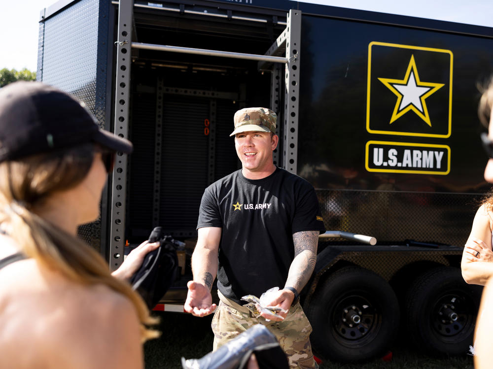 Staff Sgt. Joshua Spearman talks to fairgoers at the Army recruitment tent at the Minnesota State Fair in Falcon Heights, Minn., on August 31.