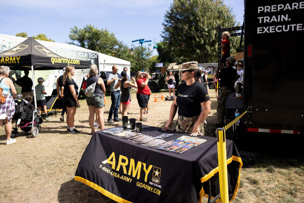 Louella Lacson, Sgt. 1st Class, talks to fairgoers at the Army recruitment tent at the Minnesota State Fair in Falcon Heights, Minn., on August 31.