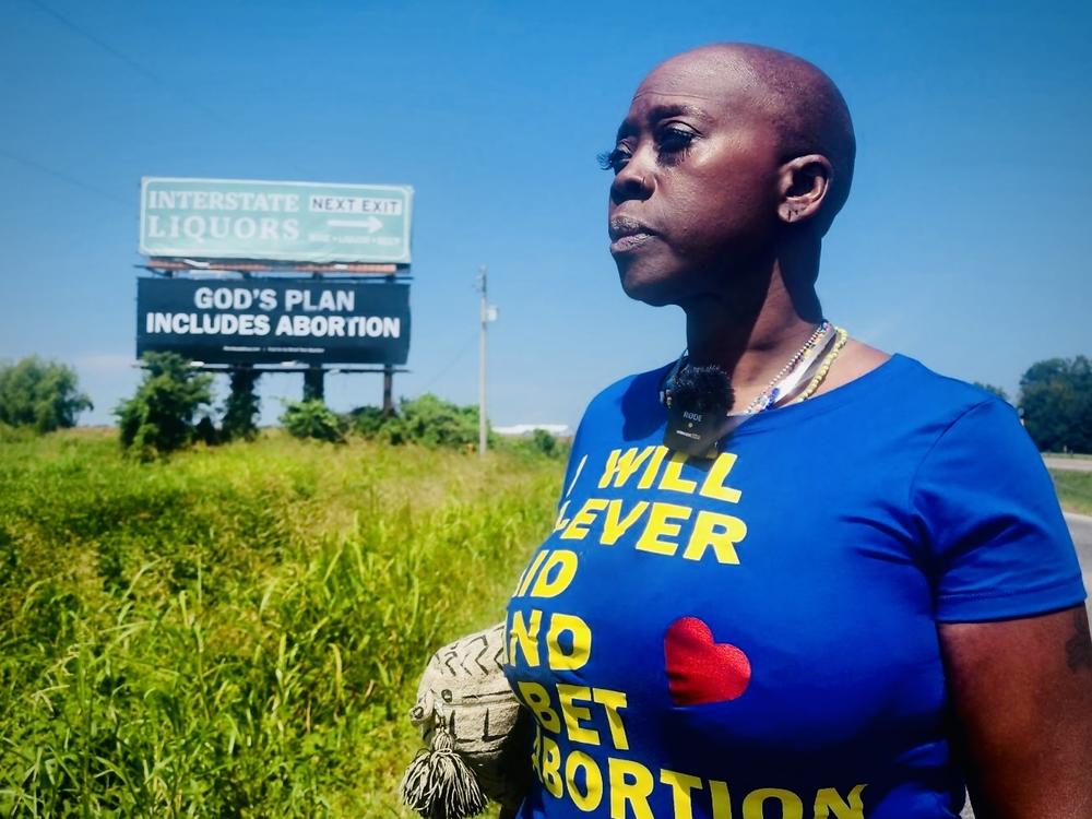 Memphis hairstylist and abortion rights advocate Queen visits a new billboard on Interstate 55 in Arkansas, placed by the group Shout Your Abortion. She says messages such as 