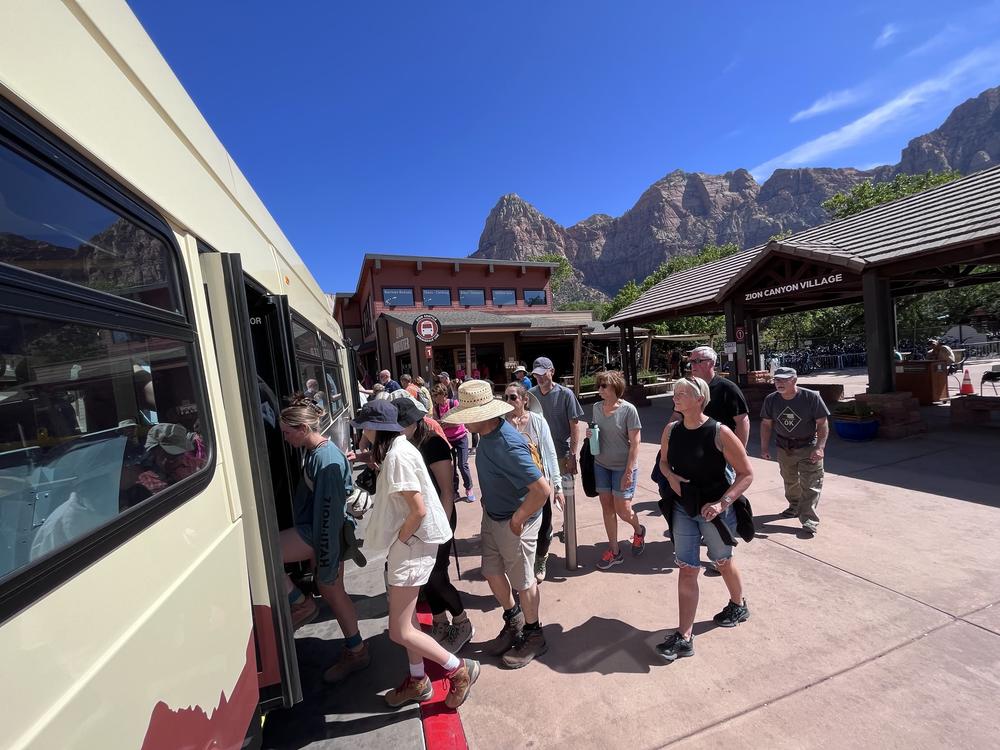 Tourists board a shuttle into Zion National Park, in Utah. The state government will pay for the park to stay open during the government shutdown, in order to keep tourist revenue flowing to nearby towns.