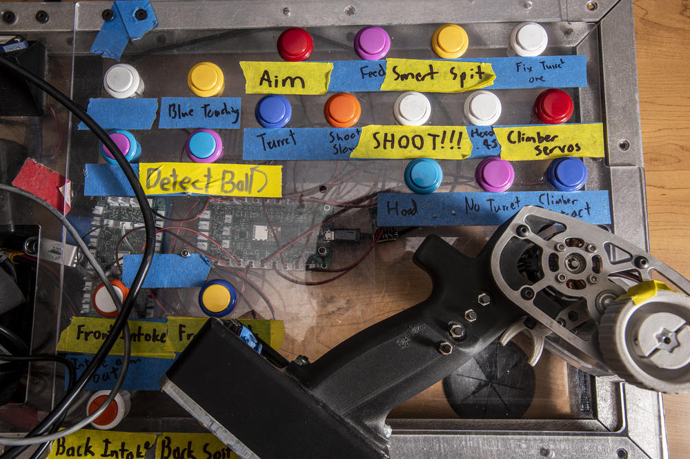 Spartan Robotics control board and pistol-grip controller from 2022, when robots had to catapult giant tennis balls into a basket and dangle from a chin-up bar.