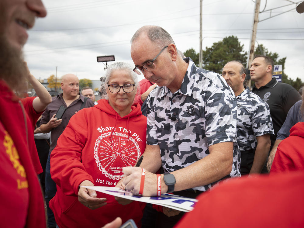 UAW President Shawn Fain greets union members as they strike the General Motors Lansing Delta Assembly Plant in Lansing, Mich., on Sept. 29, 2023. So far, the UAW has not yet targeted the most profitable parts of the Big Three automakers' production.