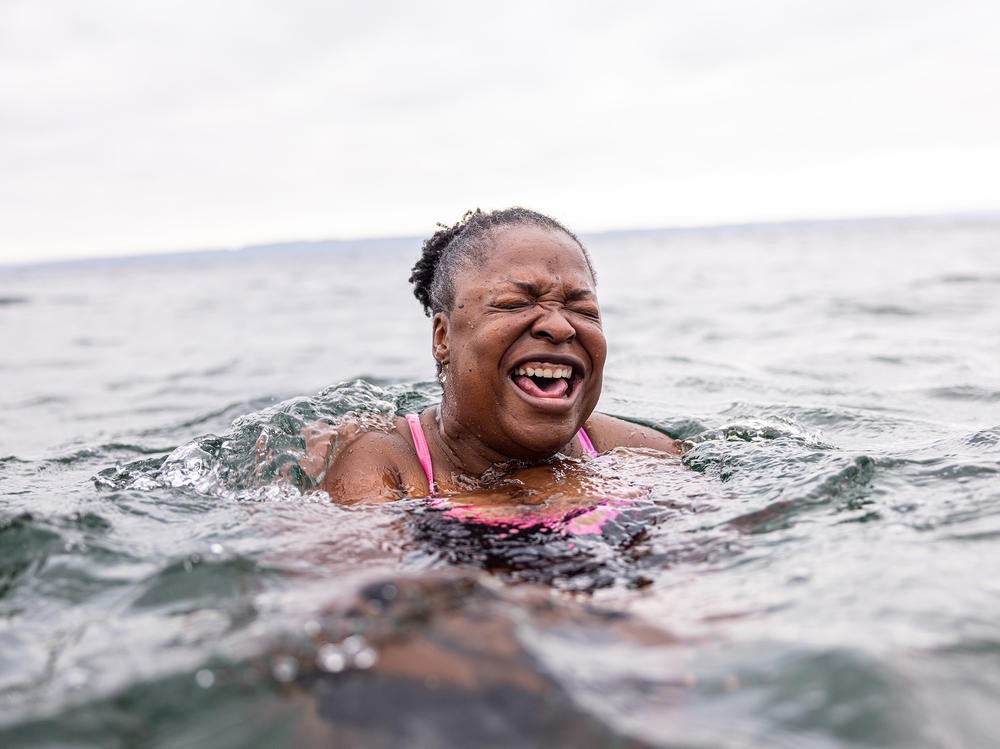 Mikki Smith lets out a cry as she adjusts to the frigid water. It was her first time with the Puget Sound Plungers in Seattle, Washington.