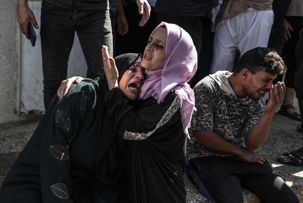 Sat., Oct. 7: Relatives of Palestinians, killed by Israeli forces during airstrike clashes, mourn after they were taken to the morgue of Shifa Hospital in Gaza City, Gaza.