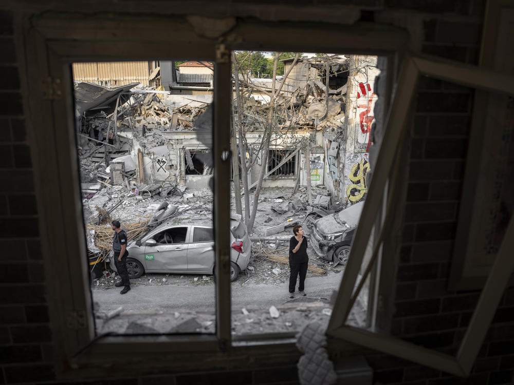 Sun., Oct. 8: Israelis inspect the rubble of a building a day after it was hit by a rocket fired from the Gaza Strip, in Tel Aviv, Israel.