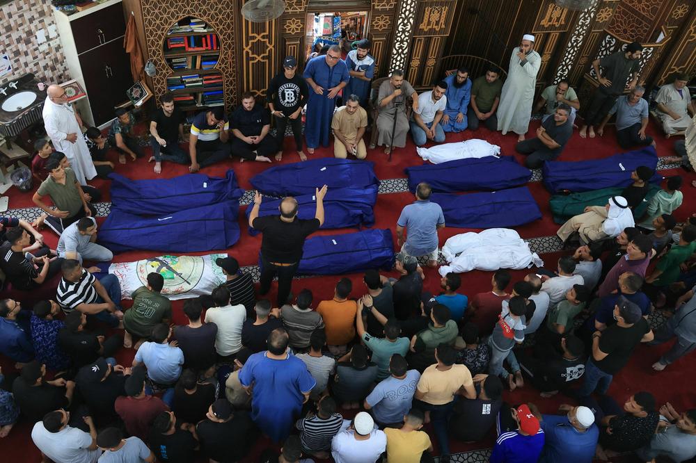 Sun., Oct. 8: People gather at a mosque to pray over the bodies of the Abu Quta family and their neighbors, killed in Israeli strikes on the Palestinian city of Rafah in the southern Gaza Strip.