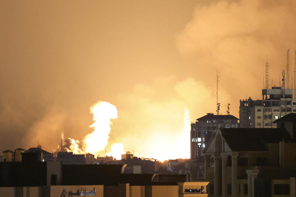 A plume of smoke rises above buildings in Gaza City during an Israeli air strike on Sunday.