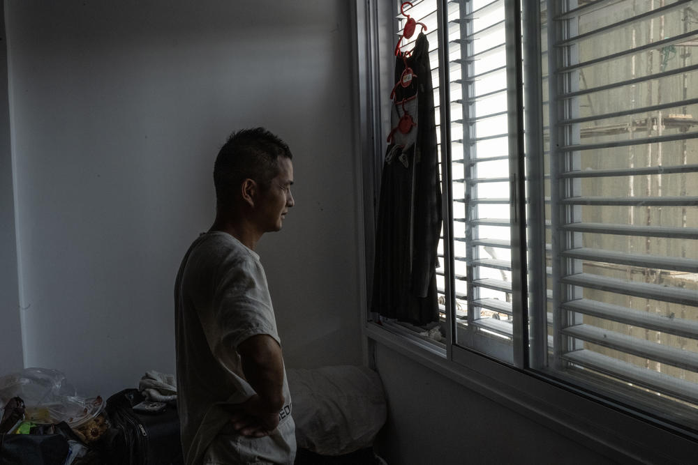 Jiang Hua is one of eight guest workers from China in a crowded apartment room in Sderot, Israel.