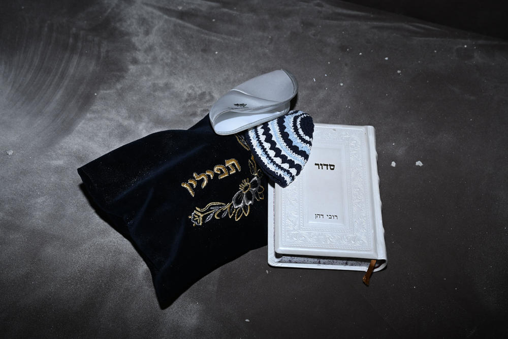 Jewish religious items — yarmulkes, phylacteries and a prayer book — left behind in a reinforced safe room which was damaged in a rocket attack the previous day, in Sderot, Israel.