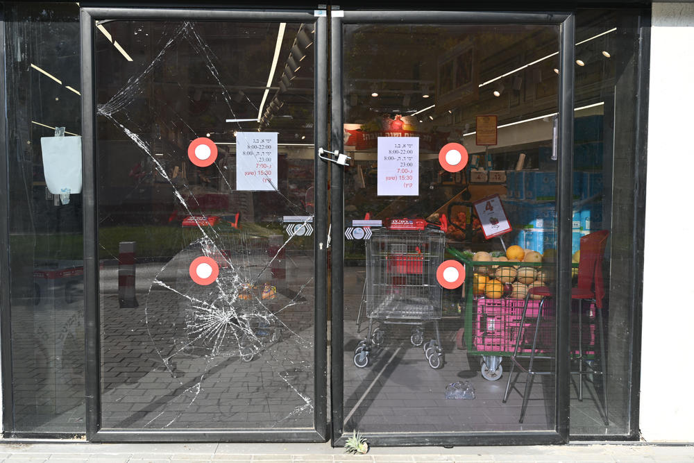 Shattered glass at the entrance to a closed grocery store in Sderot, Israel.