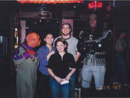 Regina (the author) shortly after she got a bachelor's degree in physics. Regina, her sister Maili, and Maili's future husband Max are standing next to a Klingon to the right and a Ferengi the left.