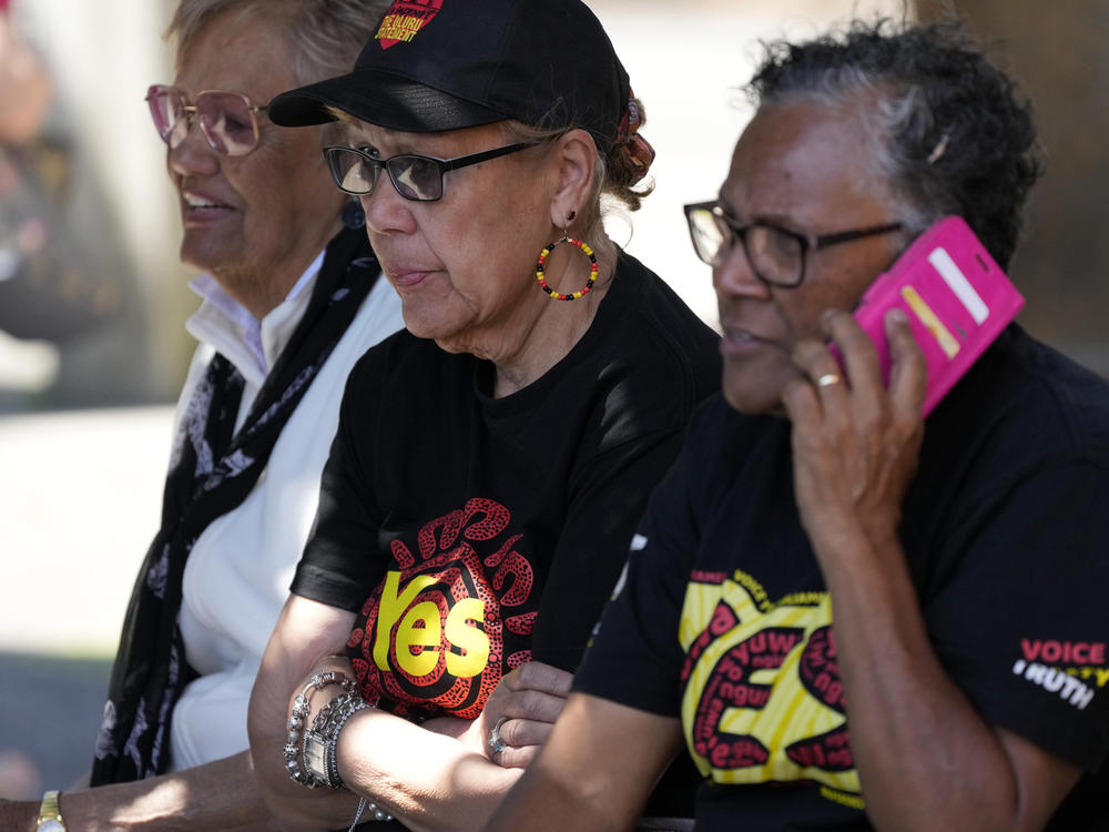 Indigenous women sit on a bench at a polling place in Sydney as Australians cast their final votes in the referendum to create an Indigenous advocacy committee to Parliament.