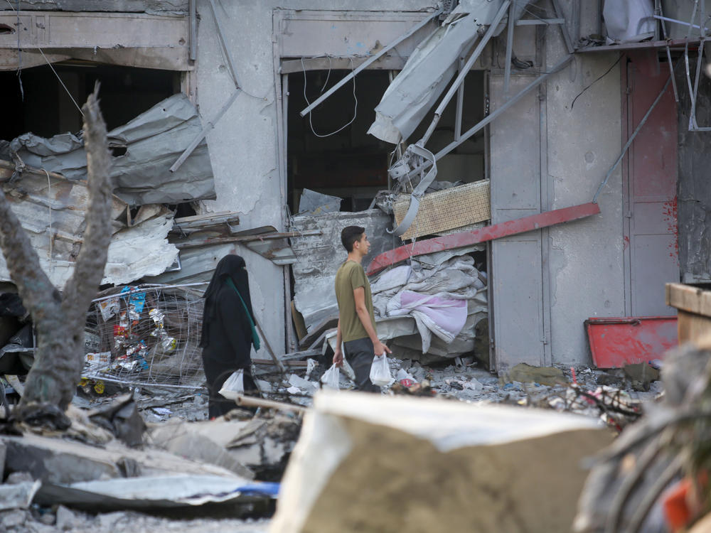 Palestinian citizens inspect damage to their homes caused by Israeli airstrikes on Saturday in Gaza City, Gaza. Many Gazan citizens have fled to the south following warnings from the Israeli government to do so.