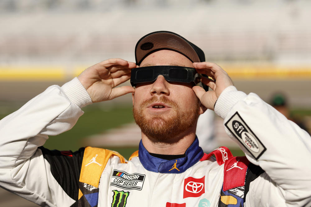 Tyler Reddick, driver of the #45 Jordan Brand Toyota, wears solar filtered glasses to view the 