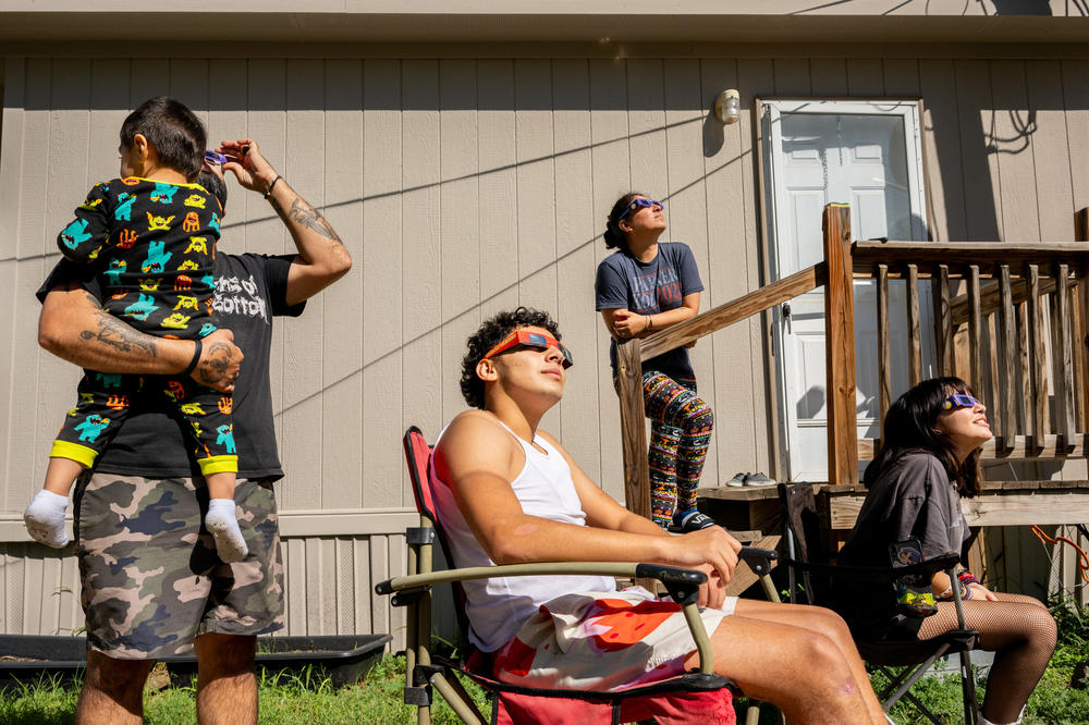 The Flores family watches the annular solar eclipse in Kerrville, Texas, on Saturday.