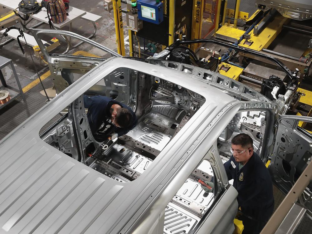 Workers assemble Ford vehicles in 2019 at the plant in Chicago.