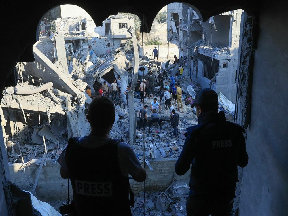 Palestinians inspect their destroyed homes following Israeli bombardment in Rafah in the southern Gaza Strip, on Wednesday, amid ongoing battles between Israel and the Palestinian group Hamas.