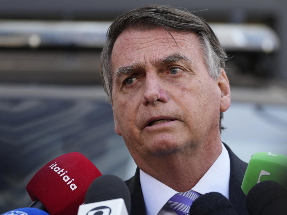 Brazil's former President Jair Bolsonaro speaks to the press as he leaves the Federal Police headquarters where he gave testimony about his actions related to the Jan. 8 attacks on government buildings in the capital, in Brasilia, Brazil, Wednesday, Oct. 18, 2023.