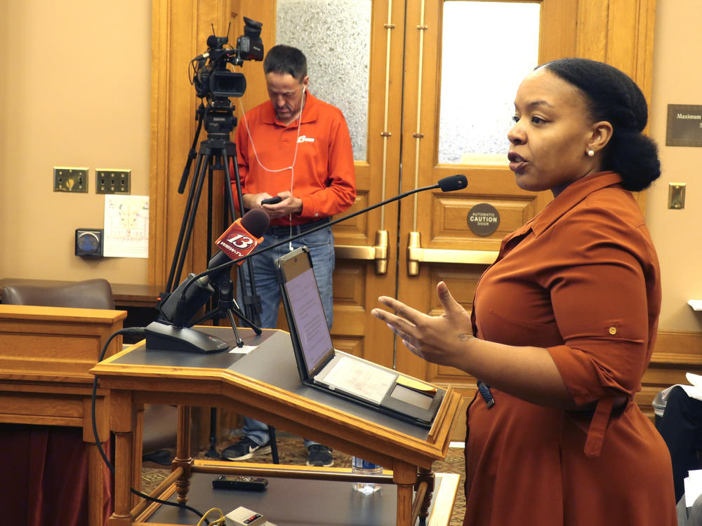 Michele Watley, founder of Shirley's Kitchen Cabinet, testifies in favor of a bill before the Kansas Legislature to ban discrimination based on hairstyles in employment, housing and public accommodations during a committee hearing, Tuesday, Jan. 28, 2020, at the Statehouse in Topeka, Kan.