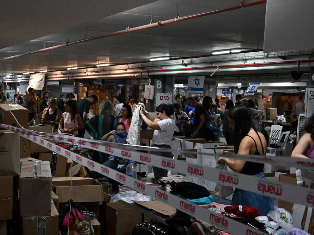 In the underground parking lot at the Expo Tel Aviv International Convention Center, thousands of volunteers help sort and distribute baby clothes, books, winter clothes, and more.
