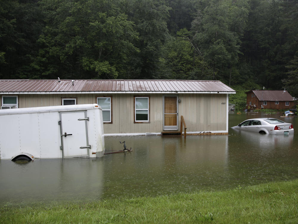 Flooding in Bridgewater, Vt., in July 2023 submerged vehicles and flooded buildings. Americans are sad, anxious and often motivated to act about climate change according to a new survey.