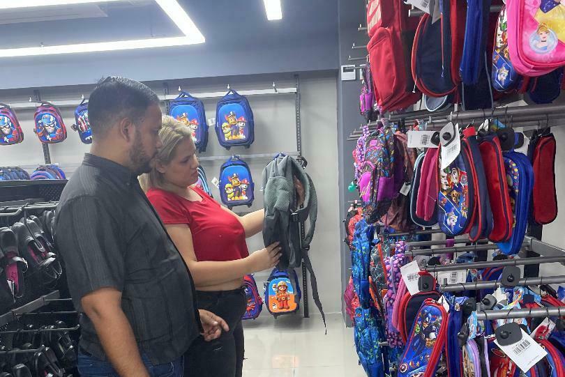 Ángel and Carolina Marín shop for backpacks of their son.