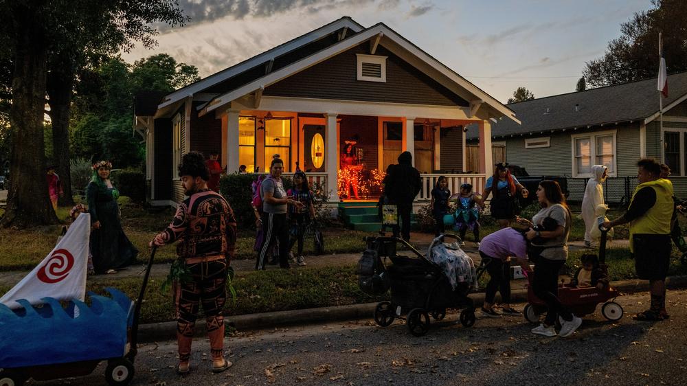 Kids and grownups visit a house for trick-or-treating in Houston, Texas, last Halloween.