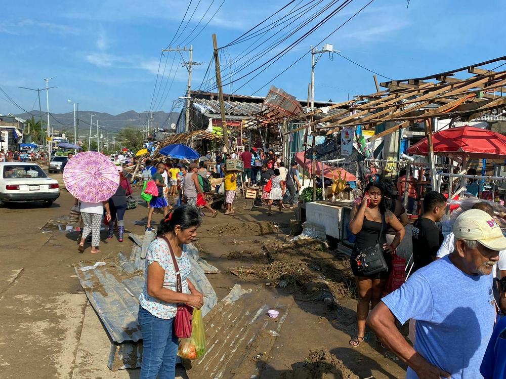 People in Acapulco descend on a local market looking for food as many shops closed following the hurricane.