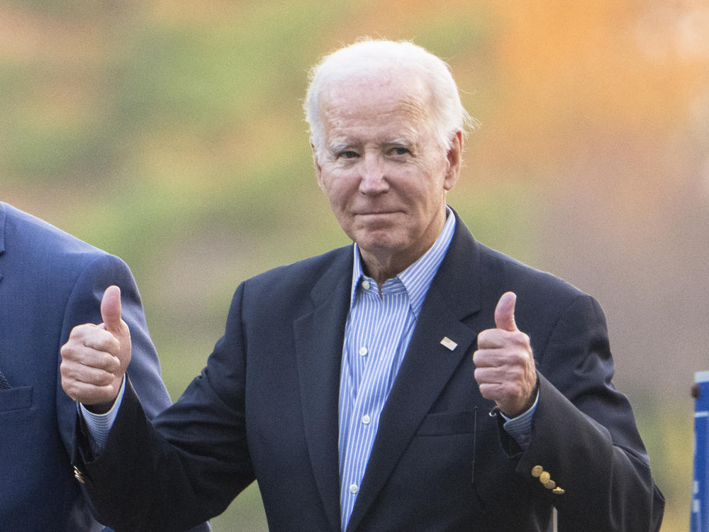 President Biden gestures with two thumbs up responding to a question from the media about UAW deal as he leaves St. Joseph on the Brandywine Catholic Church in Wilmington, Del., on Oct. 28.