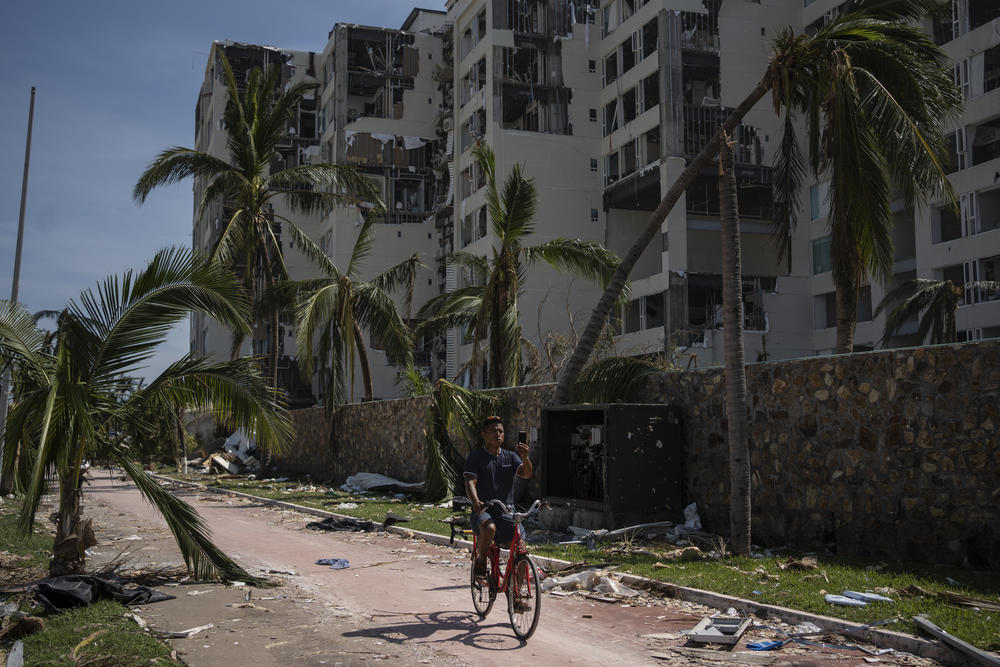 <strong>Oct. 29:</strong> A man rides at a damaged zone in the aftermath of Hurricane Otis in Acapulco, Mexico.