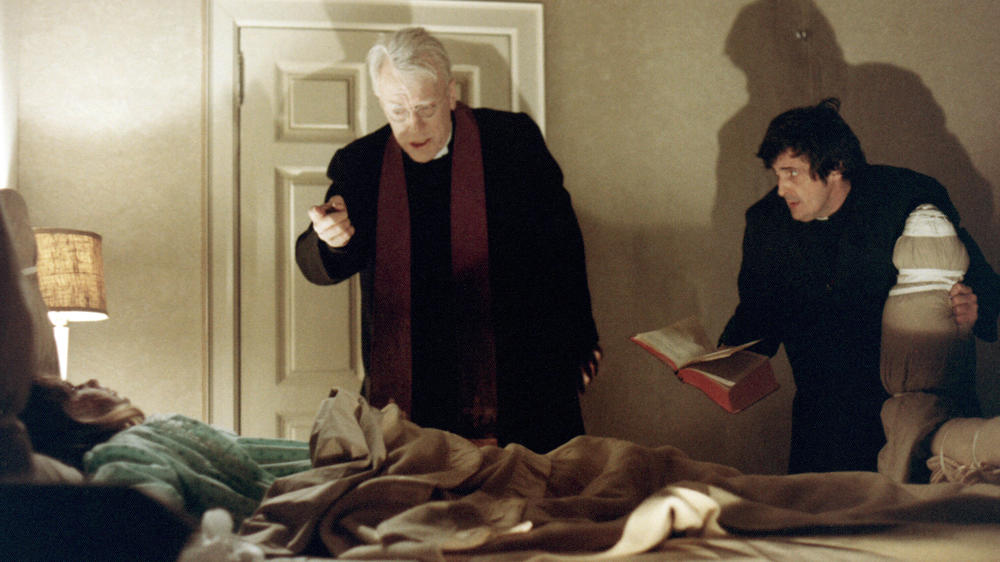 Priests, played by Max von Sydow and Jason Miller, try to help a possessed child in <em>The Exorcist,</em> from 1973.