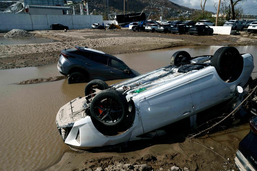 <strong>Oct. 27:</strong> Cars lay partially under water in the aftermath of hurricane Otis at 