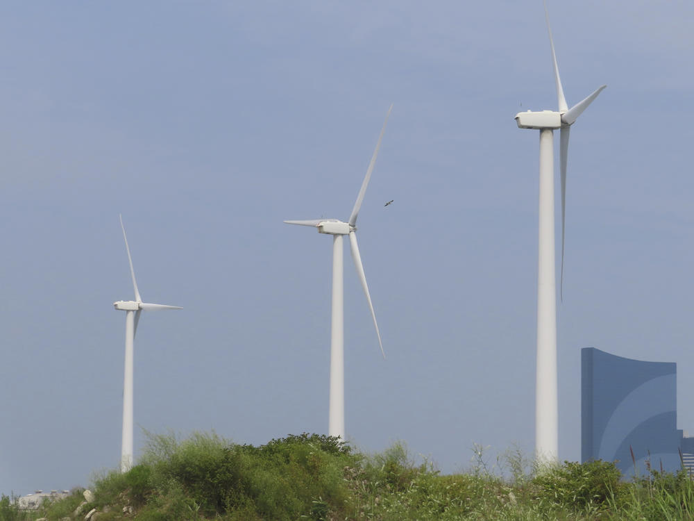 Land-based wind turbines spin in Atlantic City N.J. on July 20, 2023. Wind developer Orsted scrapped plans for two large offshore projects in New Jersey this week, citing supply chain problems and high interest rates.