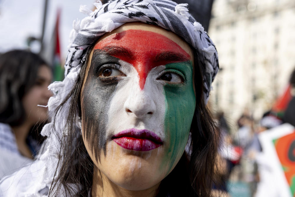 A Pro-Palestianian demonstrator wears the colors of the Palestinian flag on her face Saturday as thousands march in Washington, D.C., calling for a ceasefire in Gaza.