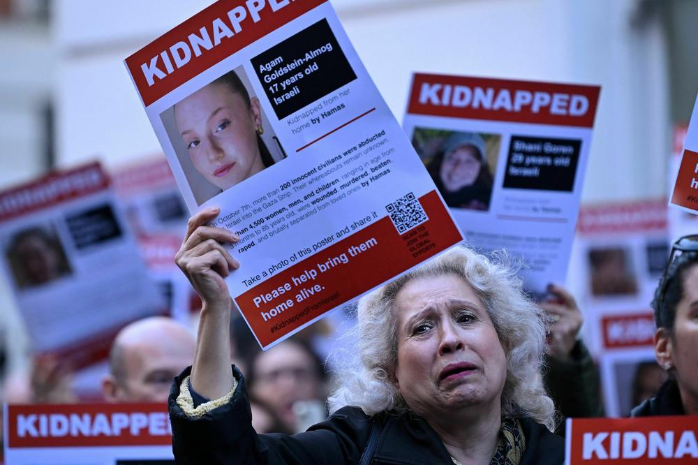 A poster showing the kidnapped Israeli Agam Goldstein-Almog is held up as people gather outside the Qatari Embassy in London on October 29 to demand the release of the estimated 230 hostages held in Gaza by Hamas after the attacks inside Israel on October 7.