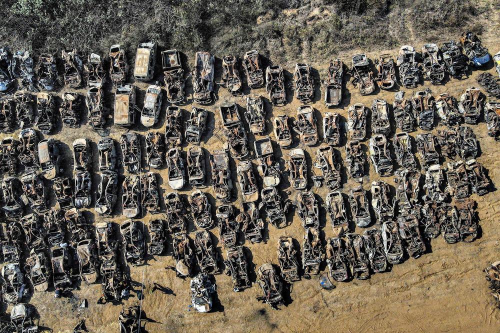 This aerial view shows some of the hundreds of burnt vehicles that were destroyed in the October 7 attack carried out by Palestinian militants from the Gaza Strip, after they have been collected from that area and transported outside the city of Netivot in southern Israel on Wednesday.