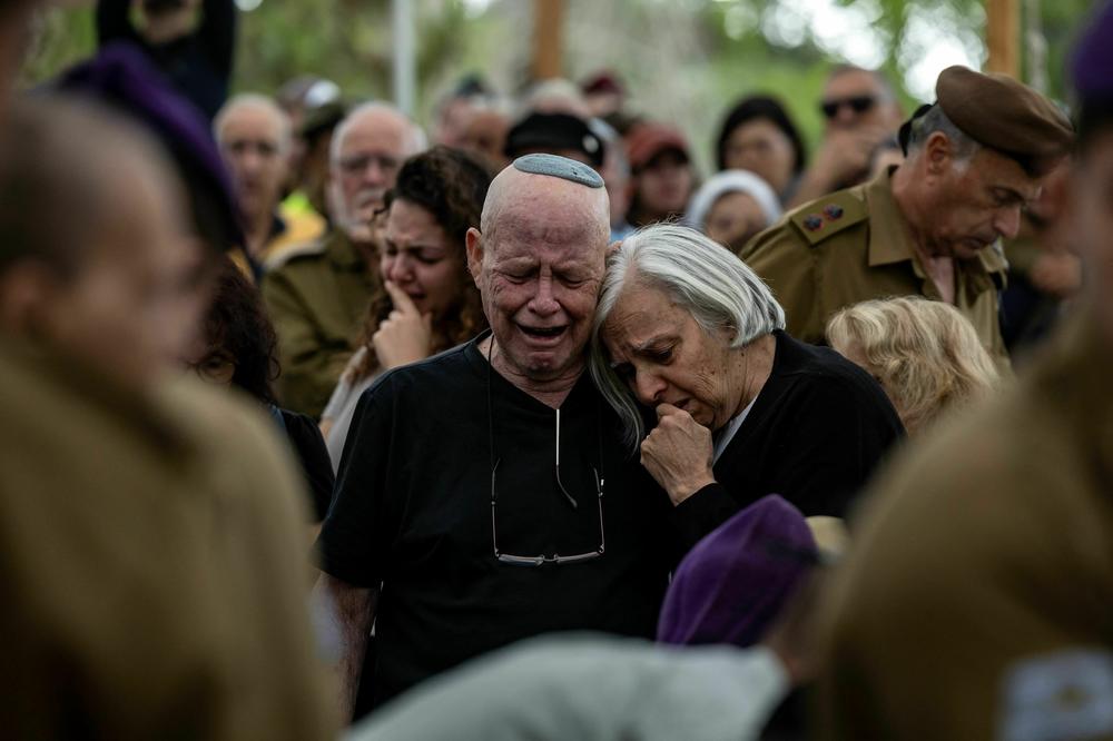 Israeli soldiers and relatives attend the funeral of a soldier on Wednesday in a military cemetery in Jerusalem amid the ongoing battles between Israel and the Palestinian group Hamas.