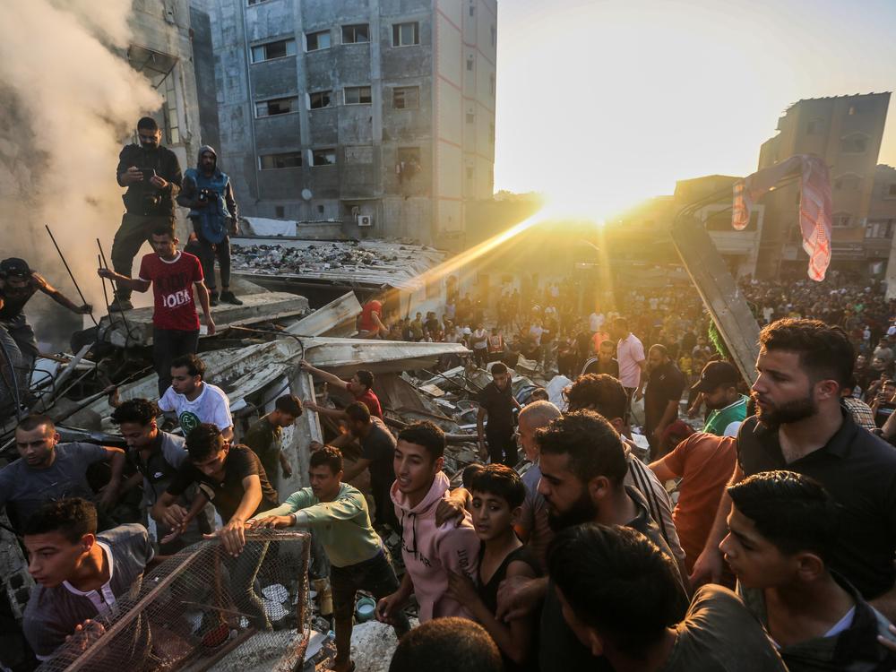 People search through buildings that were destroyed during Israeli air raids in the southern Gaza Strip Saturday in Khan Yunis, Gaza.