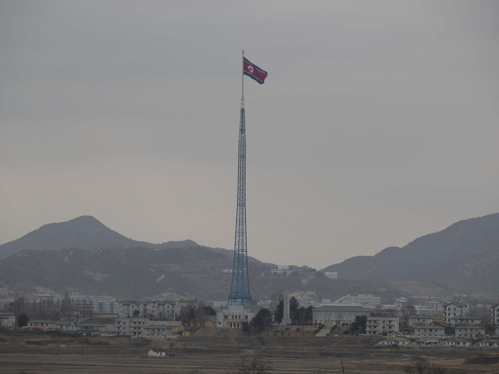 A North Korean flag flutters in North Korea's village Gijungdong as seen from a South Korean observation post inside the demilitarized zone in Paju, South Korea on March 3, 2023. North Korea confirmed that it's closing some of its diplomatic missions abroad.
