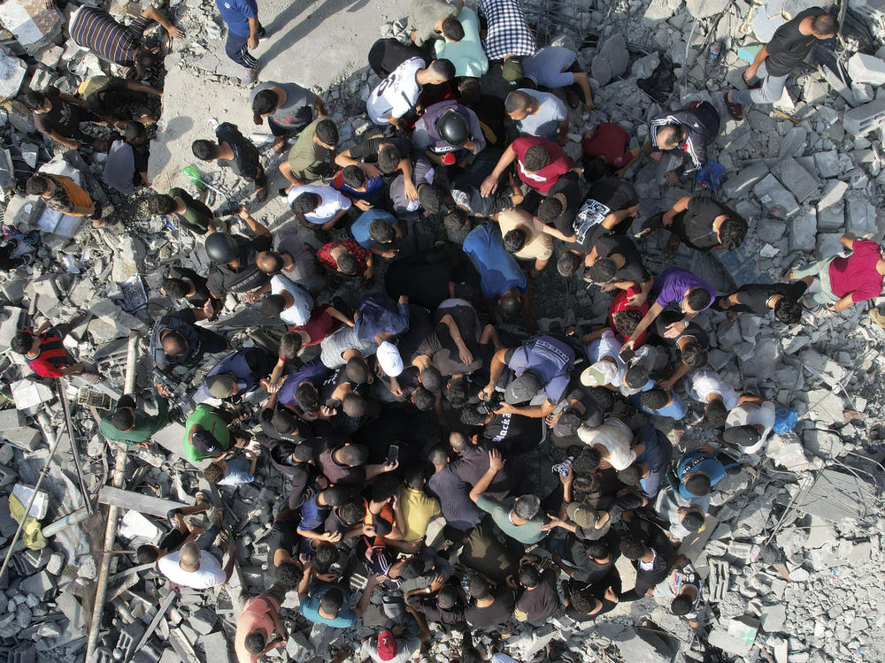 Palestinians look for survivors of an Israeli bombardment in the Maghazi refugee camp in the Gaza Strip on Sunday.