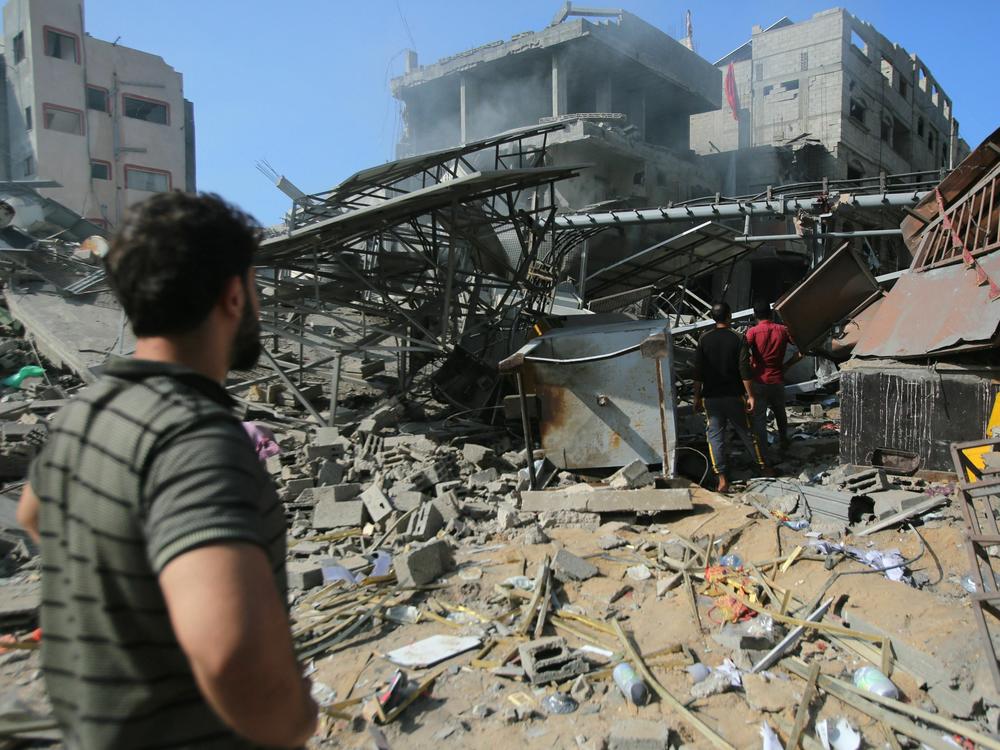 Palestinians inspect the damage in Gaza City's Shati refugee camp on Monday.