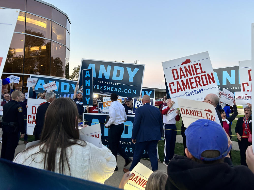 Candidates and supporters of Andy Beshear and Daniel Cameron gather ahead of a gubernatorial debate in October.