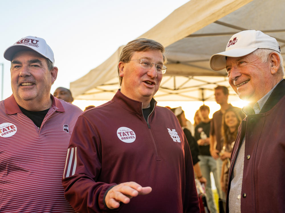 Mississippi Gov. Tate Reeves, center, greets supporters ahead of a football game at Mississippi State University on Nov. 4 in Starkville, Miss.