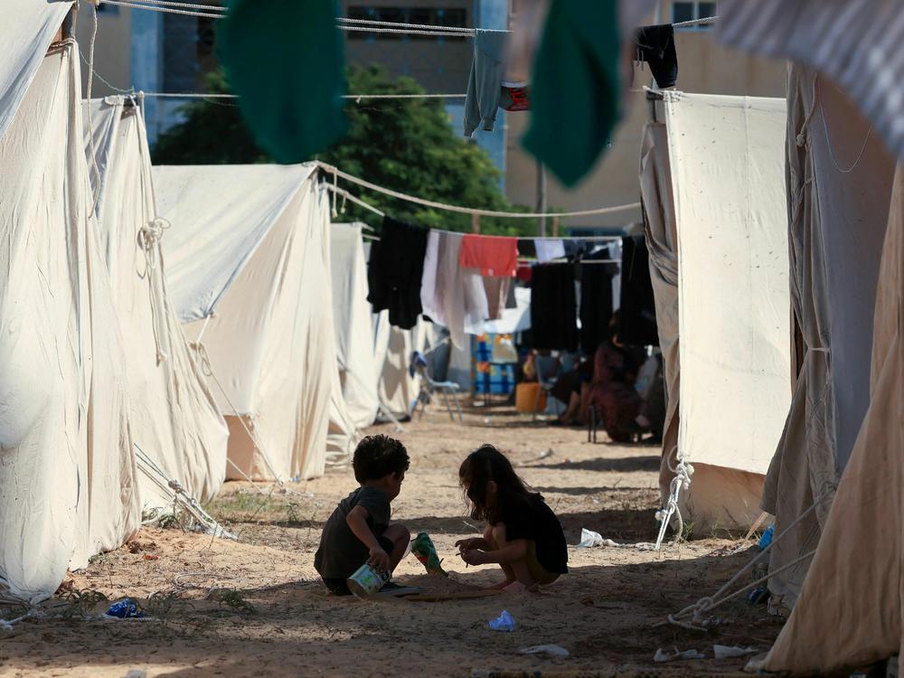Children play among tents set up for Palestinians seeking refuge on the grounds of an UNRWA center in Khan Younis in the southern Gaza Strip on Oct. 19.