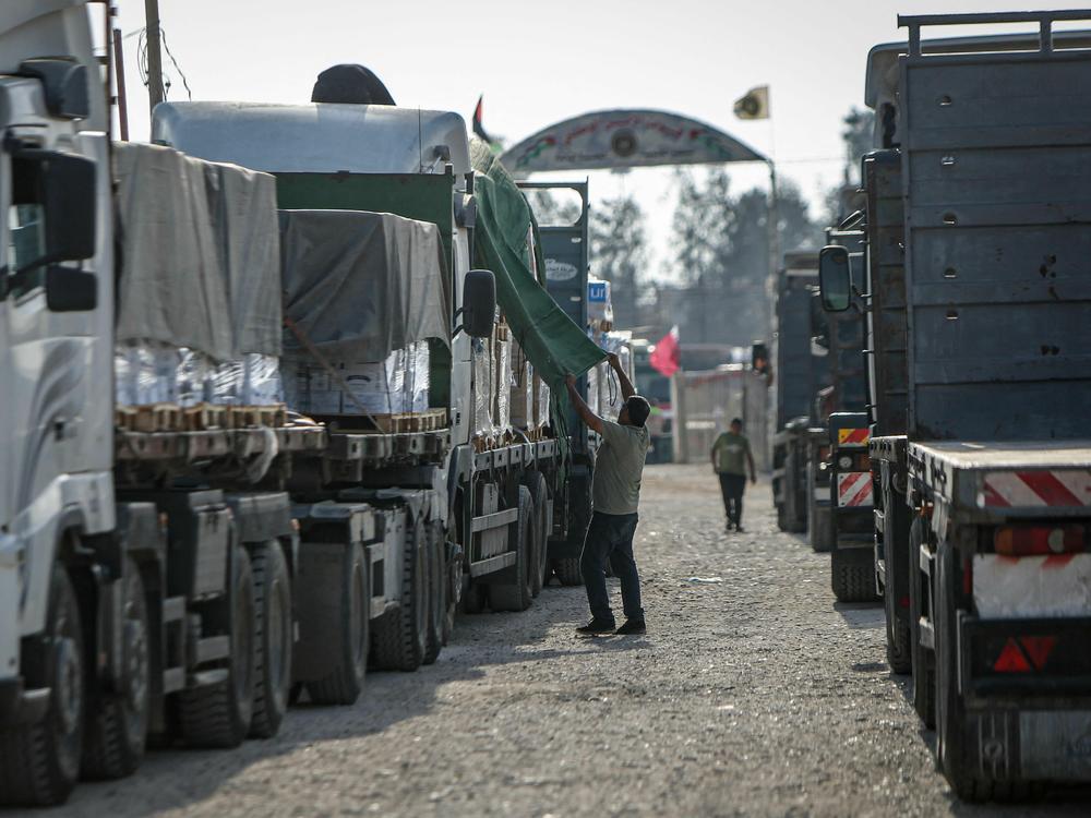 A convoy of trucks carrying humanitarian aid enters the Gaza Strip from Egypt via the Rafah border crossing on Oct. 21.