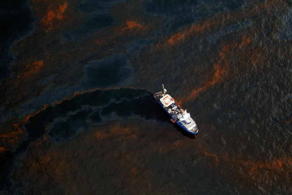A boat travels through crude oil leaked from the Deepwater Horizon wellhead near Louisiana.
