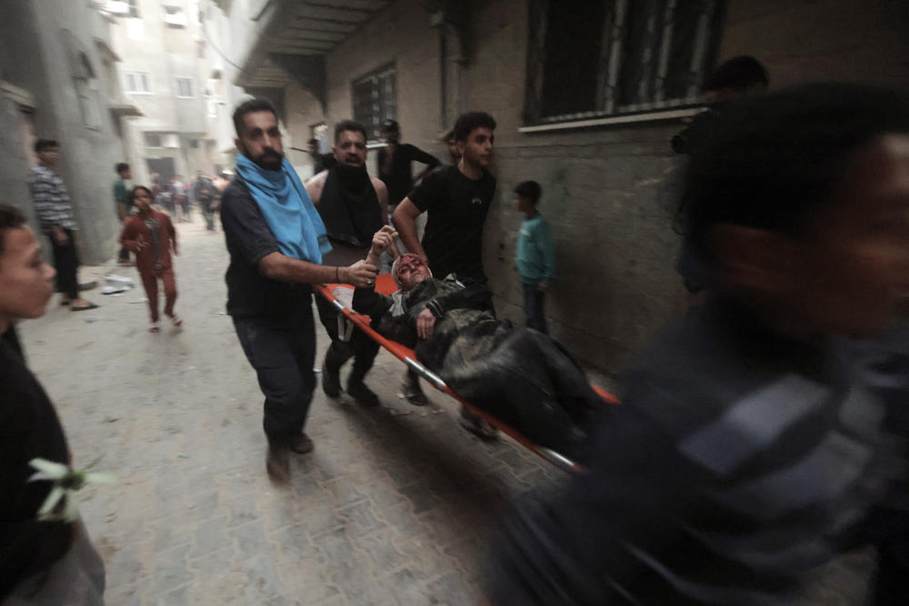Palestinians evacuate a wounded woman following an Israeli airstrike in Khan Younis refugee camp, southern Gaza Strip, Nov. 13.
