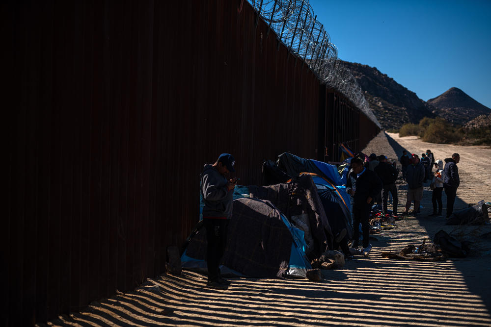Coyotes drop off migrants at a miles-long gap in the border wall in the Southern California desert, on the outskirts of Jacumba. One of the camps that has sprouted up is on private property.